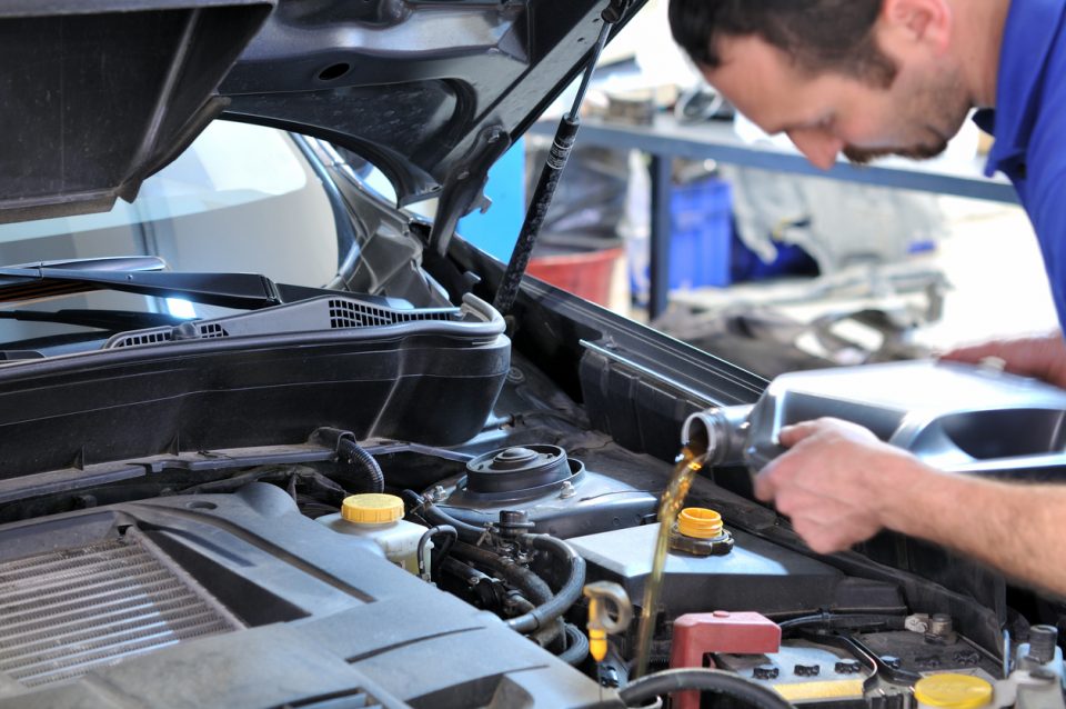 Service technician doing an oil change service