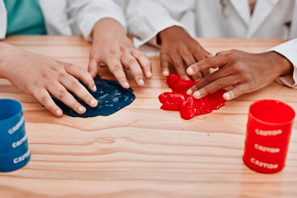 Two kids playing with slime