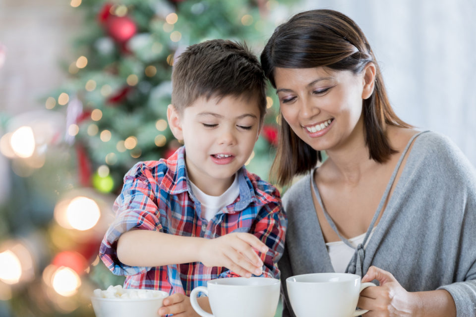 Mom prepares cocoa with young son