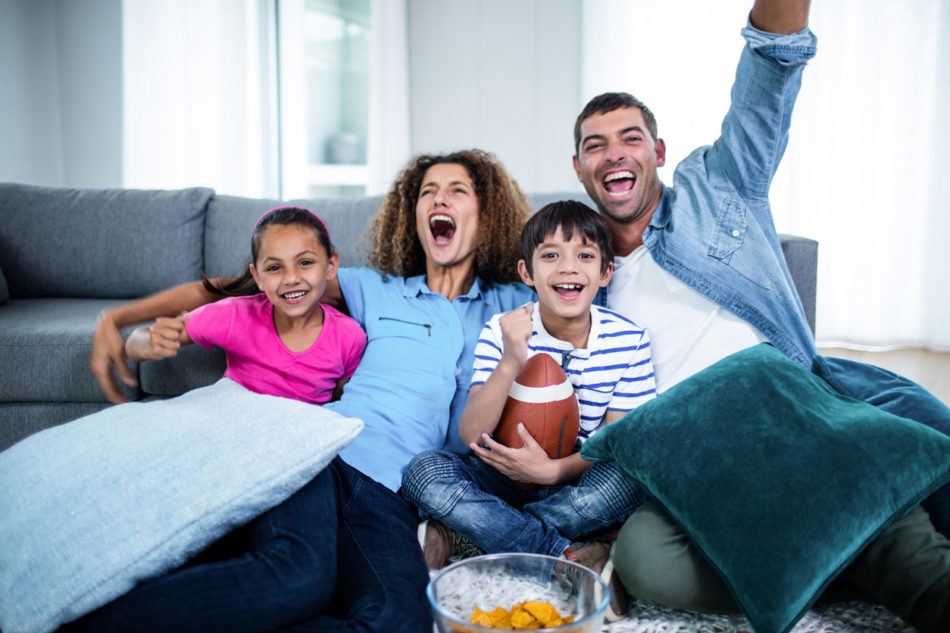 Family watching football in the living room