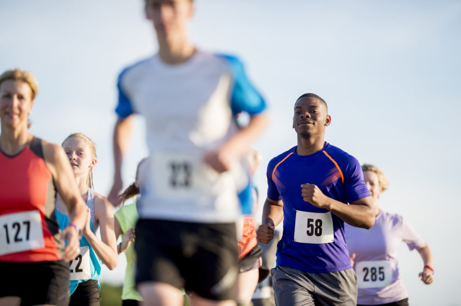 group of men and women running a 5k