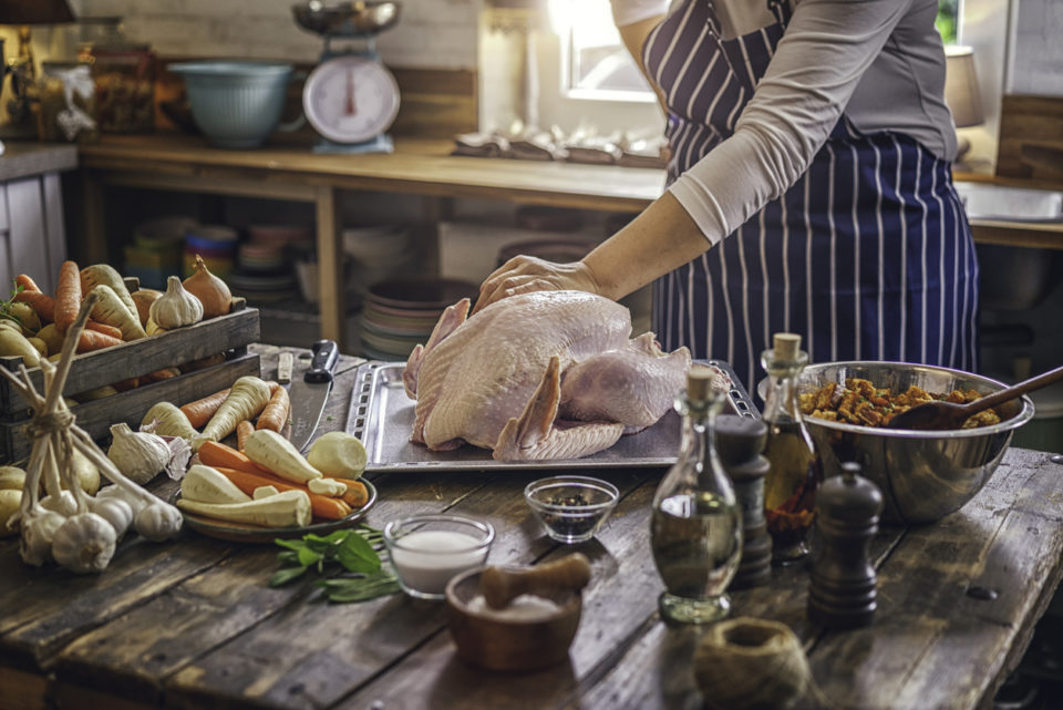 Preparing stuffed turkey with vegetables and other ingredients for holidays