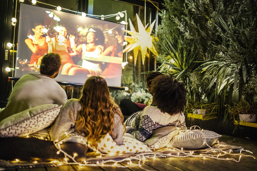 Friends making movie night at back yard