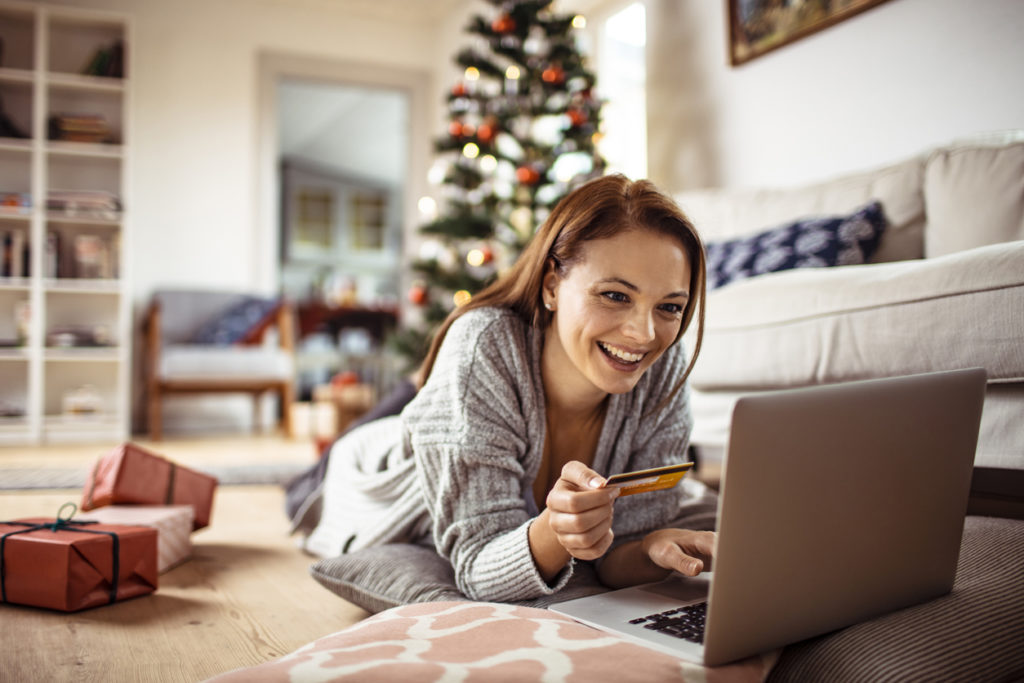 Young Woman Buying Christmas Gifts Online