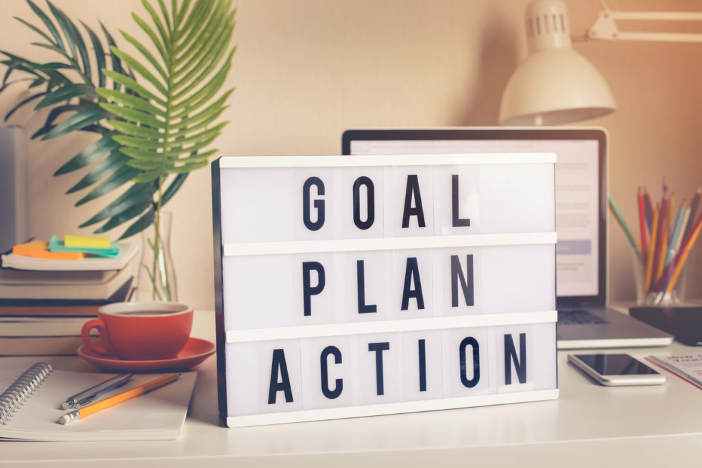 Goal,plan,action text on light box on desk