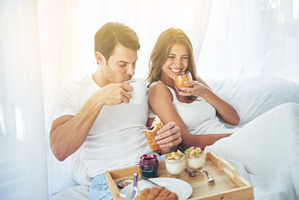 A couple having breakfast in bed