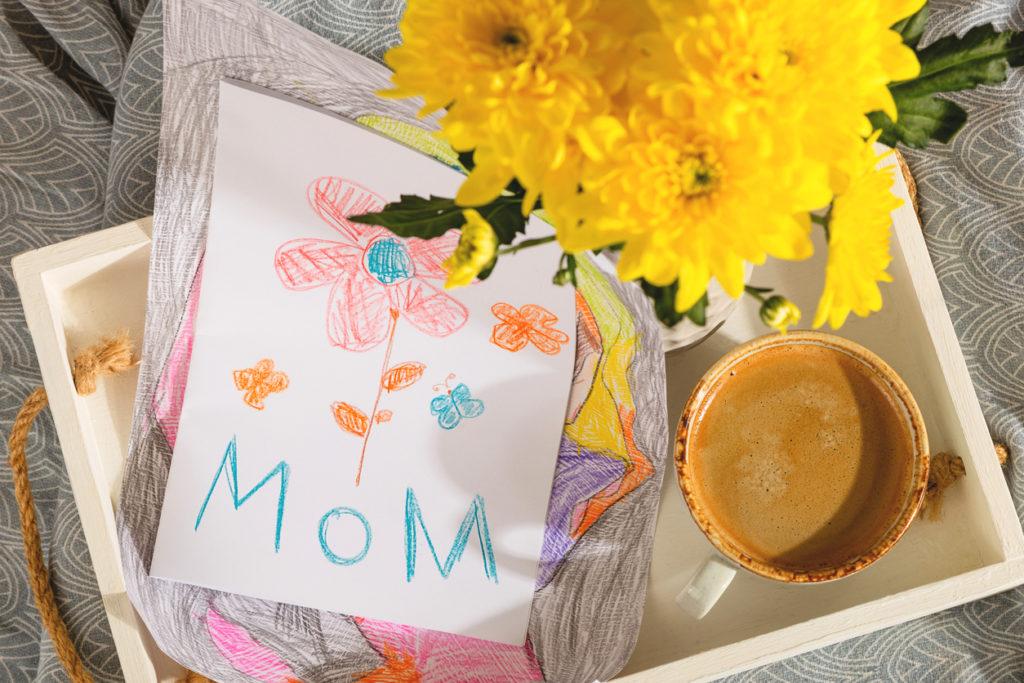 A gift from a child for mothers day - a card from a picture and coffee in bed in the morning.