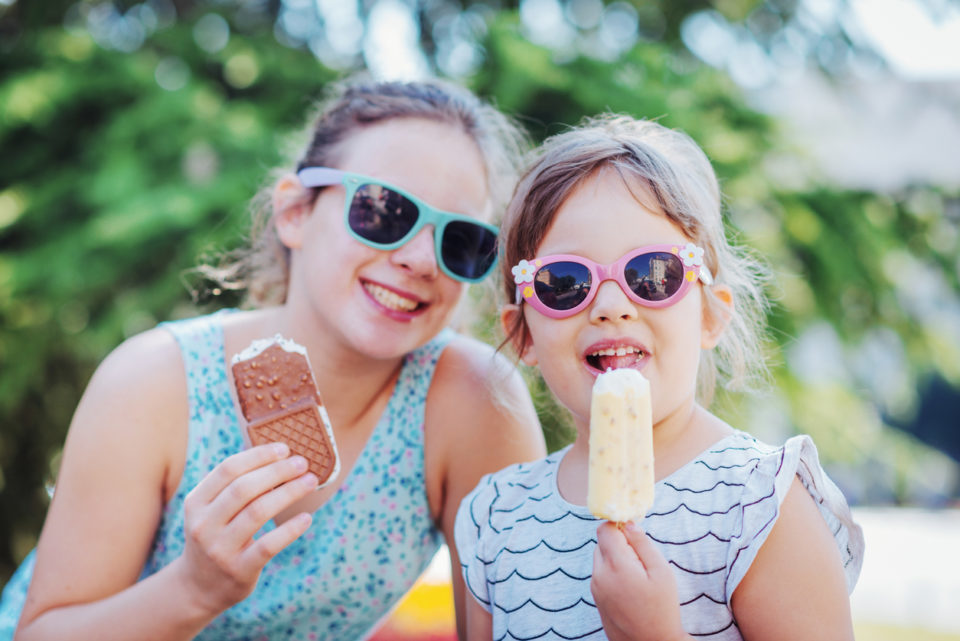 Girls eating ice-cream in summer